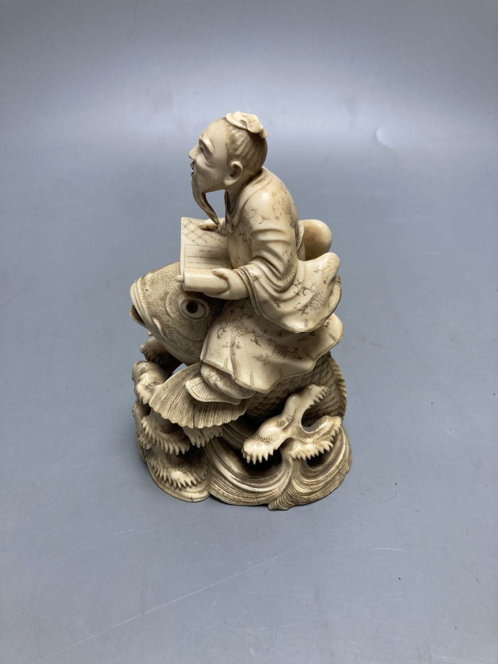 A fine Japanese ivory okimono of kinko riding a carp, 19th century, signed Ichyosen Naohide, height 15cm